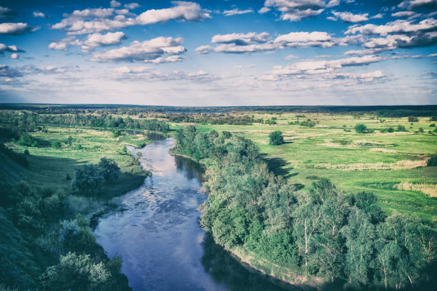 istock View from the hill to the river flowing through the meadow 926682062