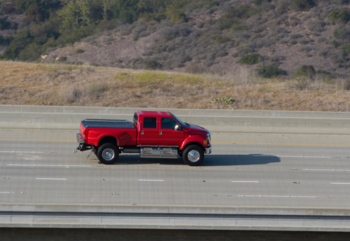 A big red truck speeds down the road.