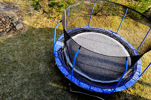 trampoline on a lawn covered with snow, view from above