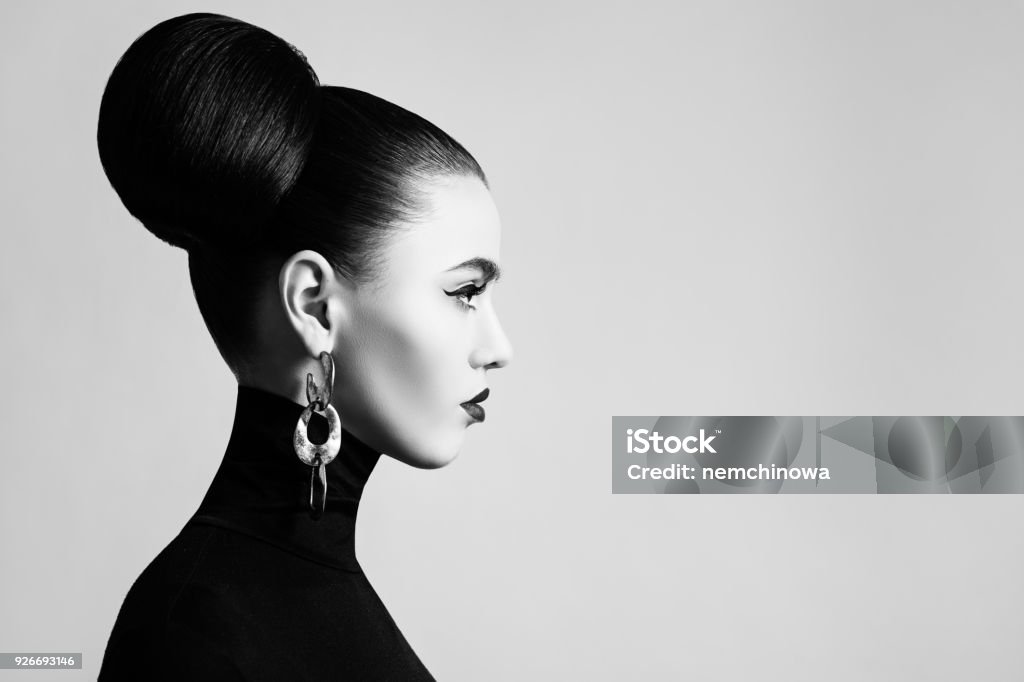 Retro style black and white fashion portrait of elegant female model with hair bun hairstyle and eyeliner makeup Fashion Stock Photo