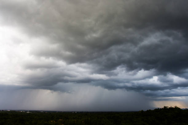 istock Dark storm clouds over meadow with green grass 926696030