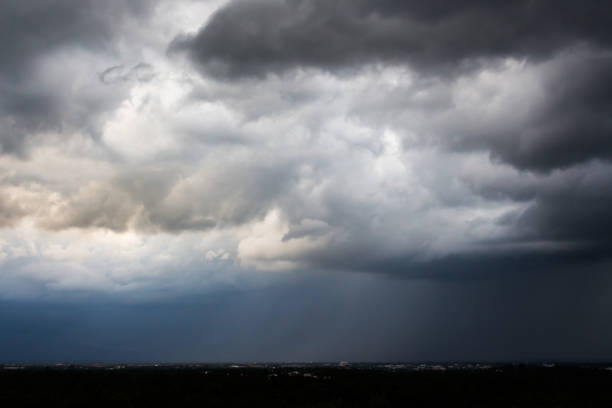 istock Dark storm clouds over meadow with green grass 926696032