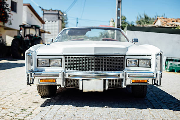 Front view of vintage classic car parked in a street. Front view of vintage classic car parked in a street. radiator grille stock pictures, royalty-free photos & images