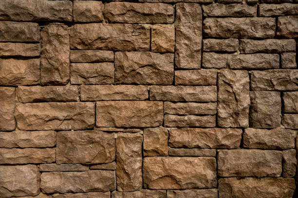 Stone wall is brown color, the rough surface texture and abstract wall.