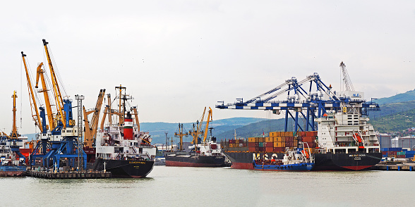 Novorossiysk, Russia - May, 2017: Novorossiysk commercial sea port.  Seaport with cranes. Tsemesskaya or Novorossiyskaya bay of the Black Sea. Transport center, ship loading and unloading
