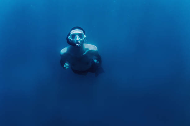 istock Freediver man swimming underwater. 926704734