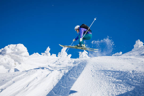 istock Woman jumping during skiing day 926715750