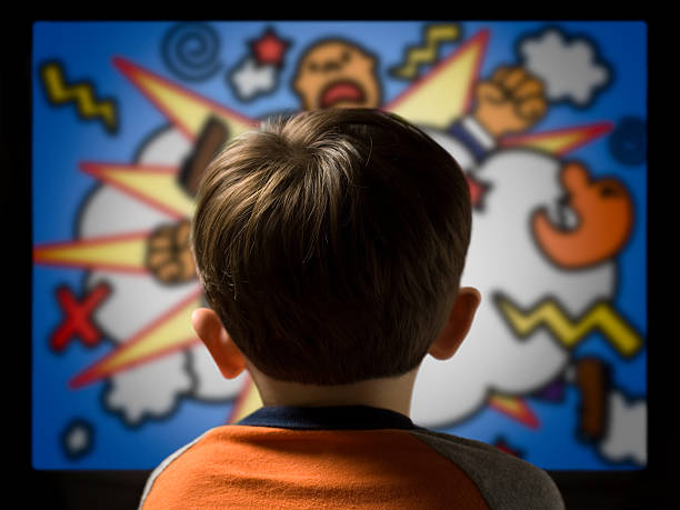 Child From Behind Watching Violent Cartoon on Television stock photo