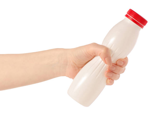istock White plastic bottle with yoghurt kefir milk in hand 926718048