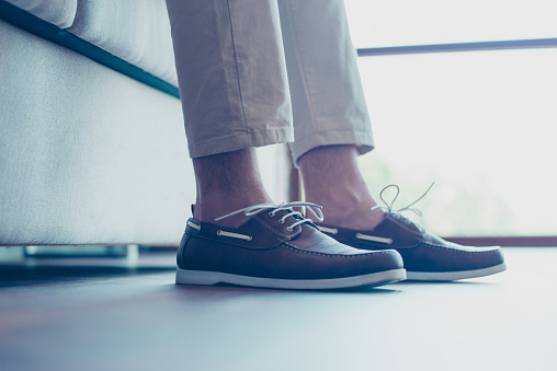 Portrait of legs with modern, fashionable men's shoes with shoelaces