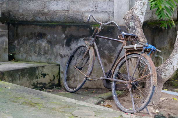 istock Parked old bicycle near stone wall in Asia. 926718678