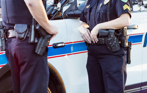 istock Policewoman and partner next to squad car 926718968
