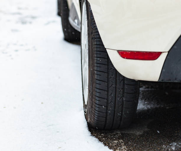 istock Car tire in winter on the road. 926726370