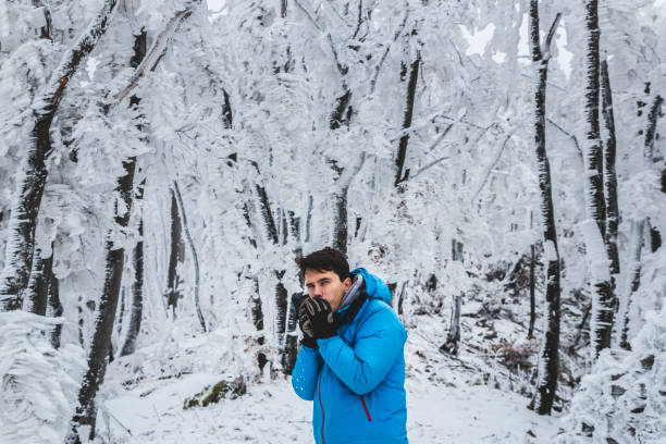 istock Winter man warming up in a frozen mountain forest 926726680
