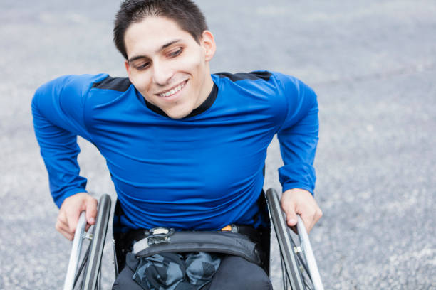 istock Young man, amputee in wheelchair, smiling 926727490