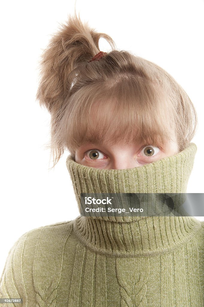 Young woman hinding face behind collar of her sweater  20-29 Years Stock Photo