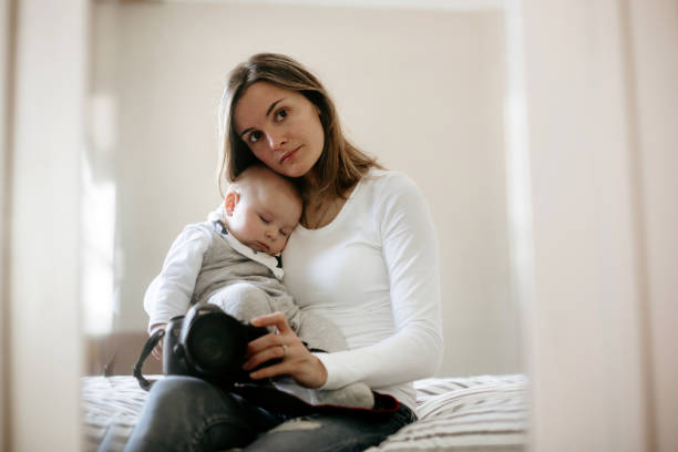 istock Young mother, holding tenderly her sleeping toddler boy 926730272