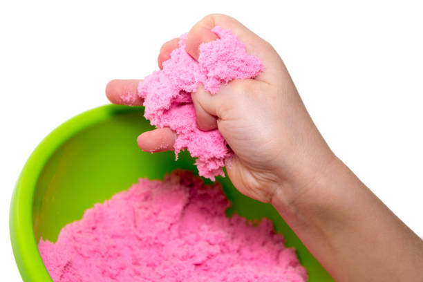hands of a kid playing with pink magic sand - sandbox child human hand sand imagens e fotografias de stock