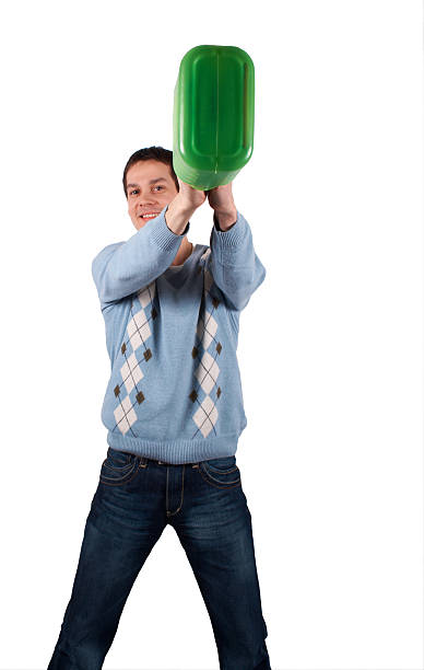 Young man lift green jerrican 3 stock photo