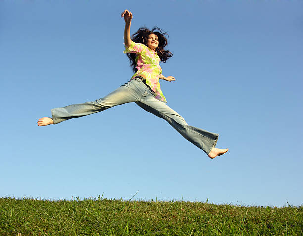 istock jump girl with hair on sky 92673256