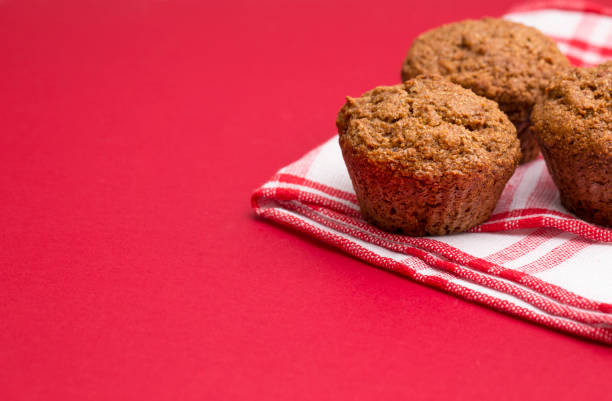 Apple Cinnamon Pecan Muffins on an Apple Red Background
