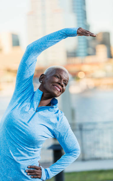 istock Senior African-American woman outdoors, stretching 926734988