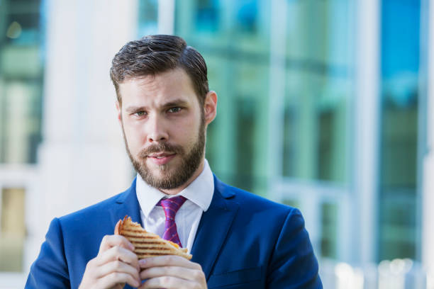 istock Young businessman eating lunch on the go 926738256