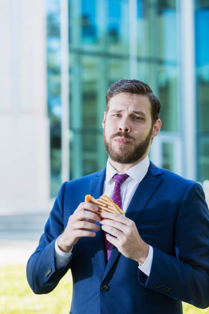 istock Young businessman eating lunch on the go 926738350
