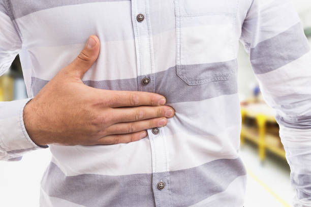 istock Gastric acid concept with man pressing his stomach 926743480
