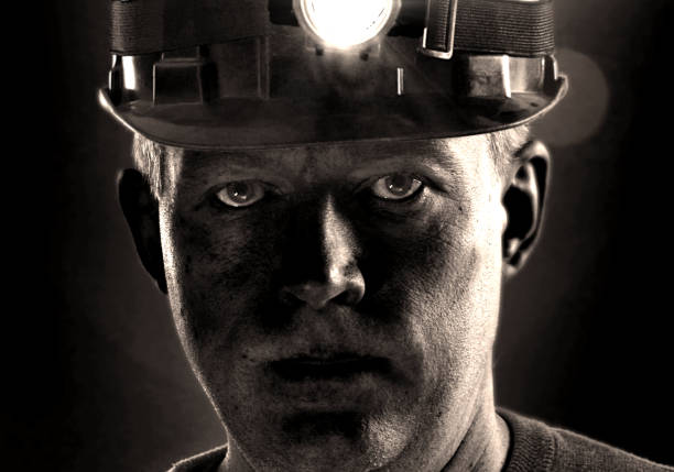 Portrait of a Latin American man working at a mine wearing a helmet
