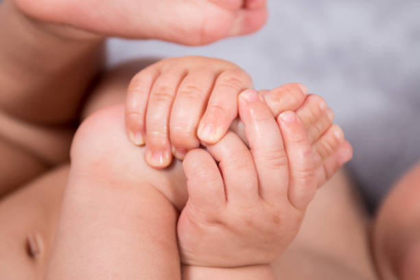 istock baby feet and hands 926749406
