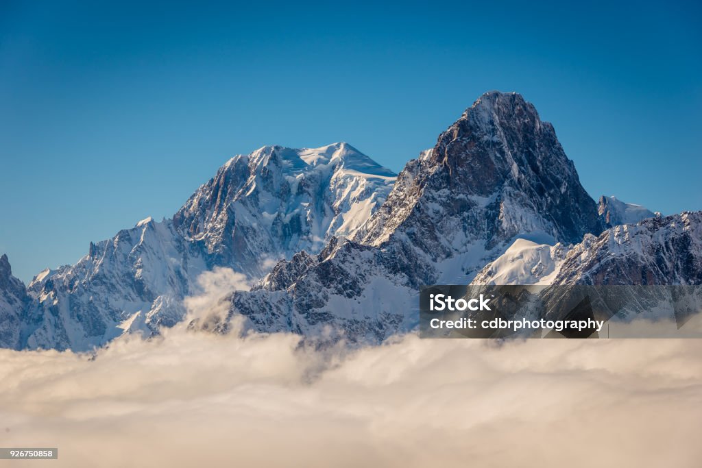 Mont Blanc above the clouds Mont Blanc and Grandes Jorasses above the winter clouds in the valley. Mont Blanc Stock Photo
