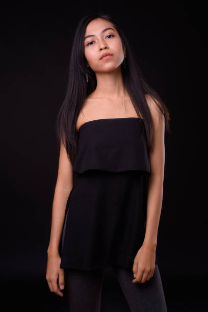 istock Young beautiful Asian woman against black background 926753678