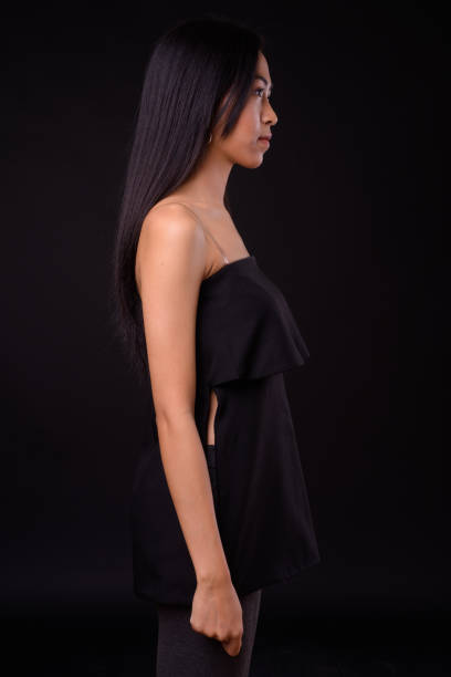 istock Young beautiful Asian woman against black background 926753818