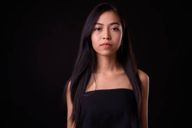 istock Young beautiful Asian woman against black background 926753900
