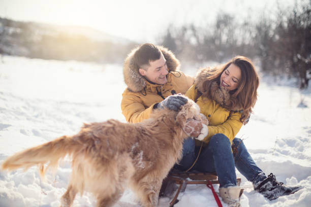 istock Love couple with dog having fun on snow 926756856