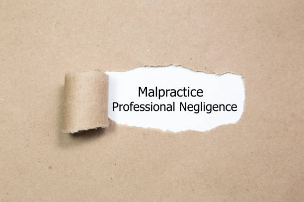 istock Text Malpractice Professional Negligence appearing behind ripped paper. 926757128