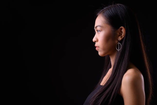 istock Young beautiful Asian woman against black background 926757264
