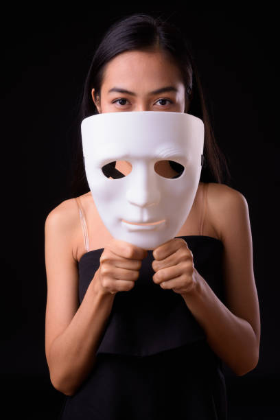 istock Young beautiful Asian woman against black background 926757718