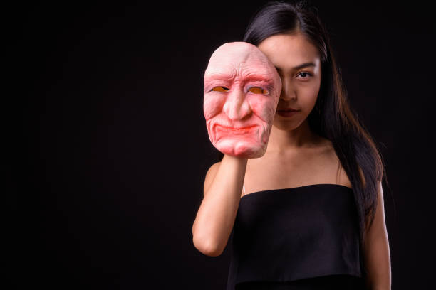 istock Young beautiful Asian woman against black background 926757890