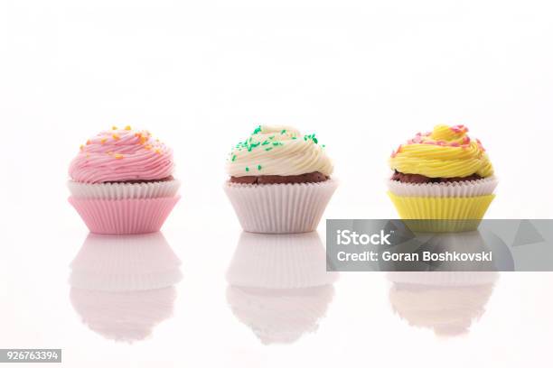 Three Delicious Muffins On A White Background Stock Photo - Download Image Now - Cupcake, White Background, White Color