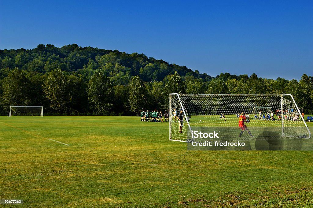 Jogadores de futebol jogando futebol no campo de futebol com bola de futebol - Foto de stock de Futebol royalty-free