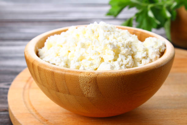 istock Home cottage cheese in a bowl on a wooden table. 926773920
