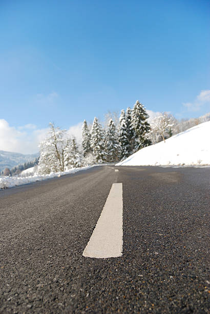 winter road - single line outdoors vertical switzerland стоковые фото и изображения