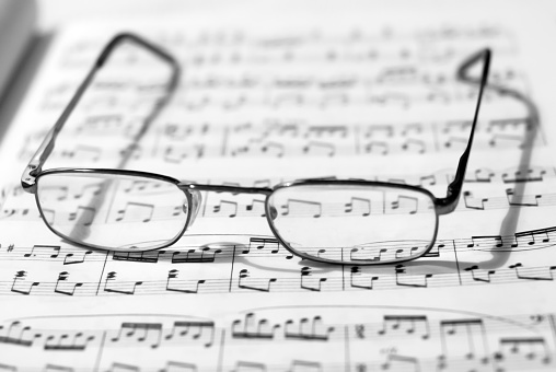 Sheet piano music and glasses for shortsightedness