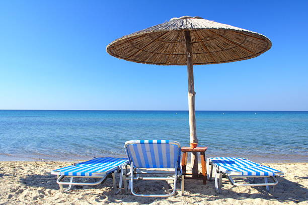istock beach umbrella and chair 92678228