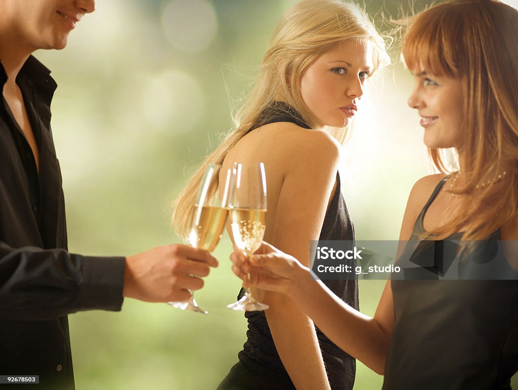 Three young people drinking, outdoors  Envy Stock Photo