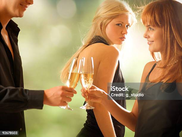 Three Young People Drinking Outdoors Stock Photo - Download Image Now - Envy, Success, Friendship