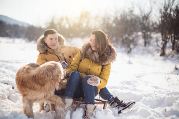 istock Love couple with dog having fun on snow 926785508