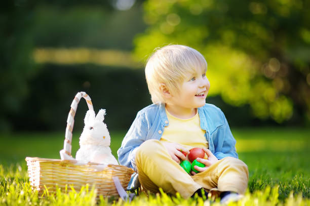 istock Charming little boy hunting for easter egg in spring park on Easter day 926786278